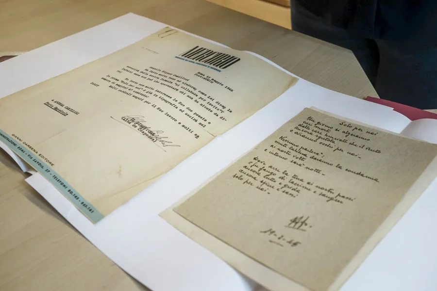 De pequeño lo guardaba todo, desde cartas escolares hasta sus primeros relatos escritos a mano, como si supiera que iba a convertirse en uno de los grandes de la literatura: Andrea Camilleri fue siempre una mente ordenada, inquieta y generosa. Y su legado permanece intacto en un archivo personal que muestra también la historia de Italia. En el año en que se celebra el centenario de su nacimiento, el Fondo Andrea Camilleri, abierto al público desde 2021 y gestionado por su familia, cobra especial protagonismo como epicentro cultural de la obra y la vida de un reconocido intelectual que fue, a su vez, uno de los autores más queridos por el público