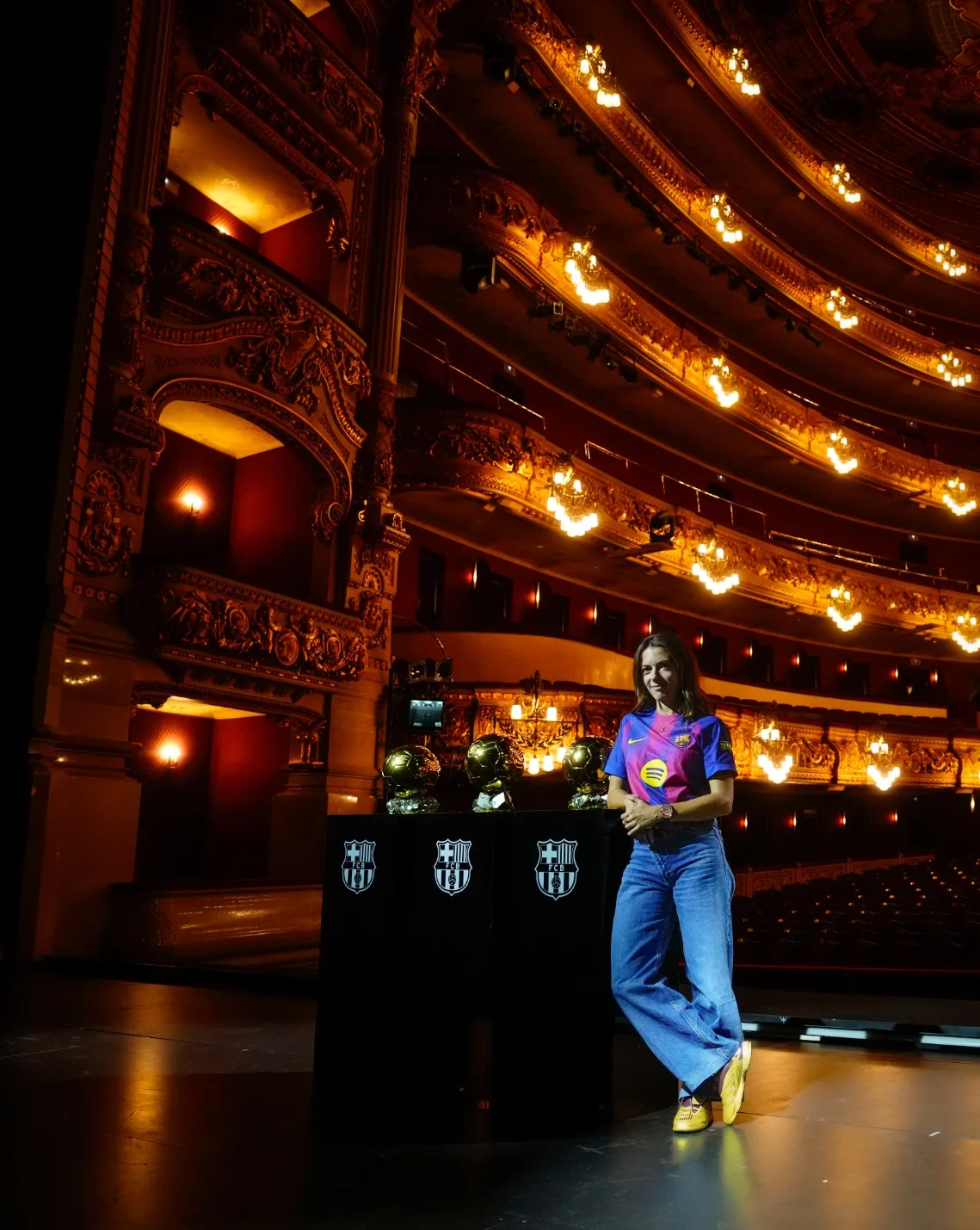 La centrocampista del Barcelona Aitana Bonmatí ha atendido a los medios tras una sesión fotográfica en el imponente Teatro del Liceo de la capital catalana, donde ha exhibido orgullosa su tercer Balón de Oro, una premio que la reafirma como la mejor futbolista del planeta. El premio, logrado por tercer año consecutivo, le reafirma como la mejor futbolista del planeta y la convierte en la primera jugadora de la historia en lograr el triplete en este galardón.
