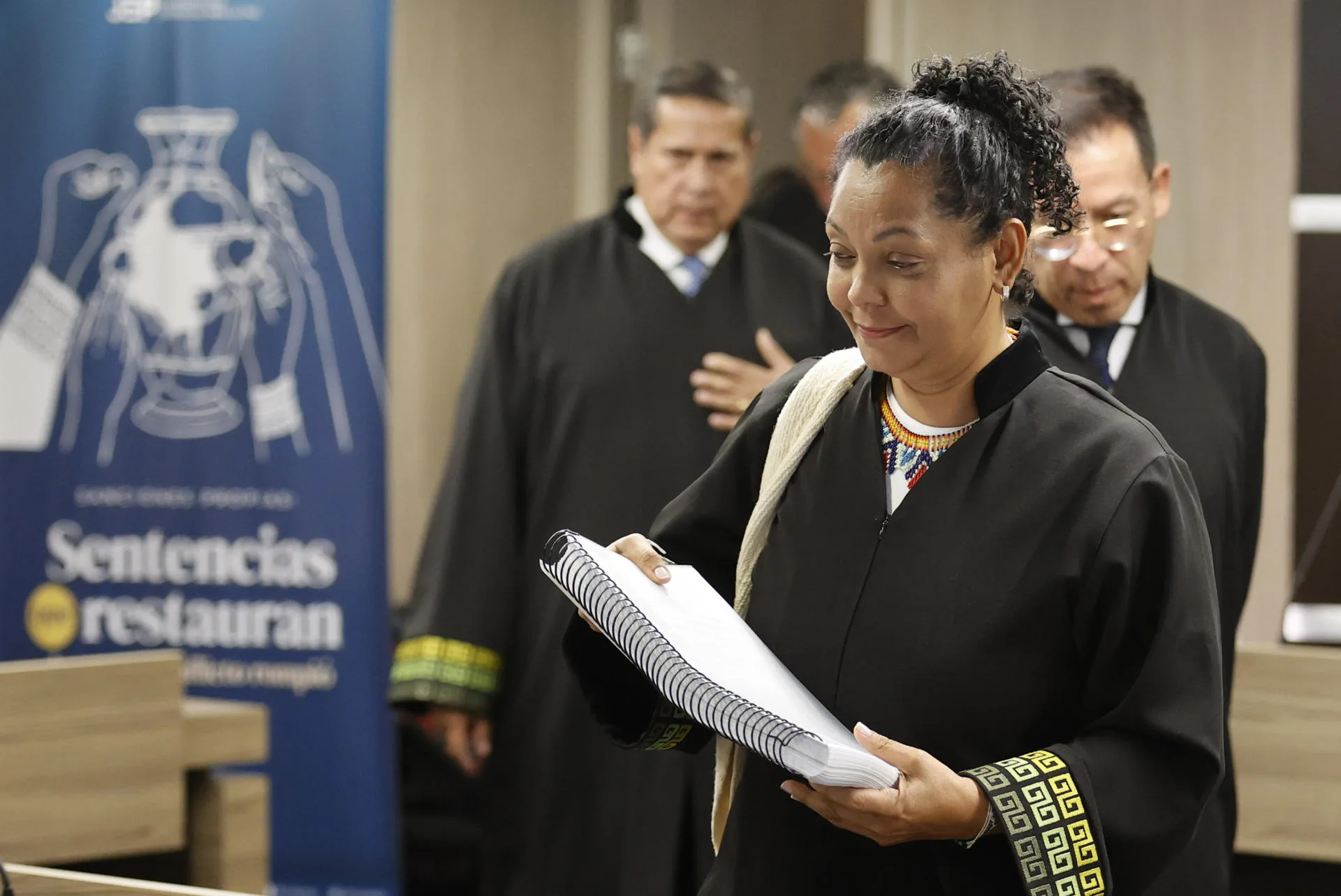 The president of the First Instance Section for Truth and Responsibility Recognition Cases, Judge Ana Manuela Ochoa Arias, upon her arrival at a hearing on Thursday, holds the document of the first ruling on murders and forced disappearances presented as combat casualties on the Caribbean coast by the ‘La Popa’ Battalion, in Bogotá (Colombia). Sep. 18, 2025. EFE/ Mauricio Dueñas Castañeda