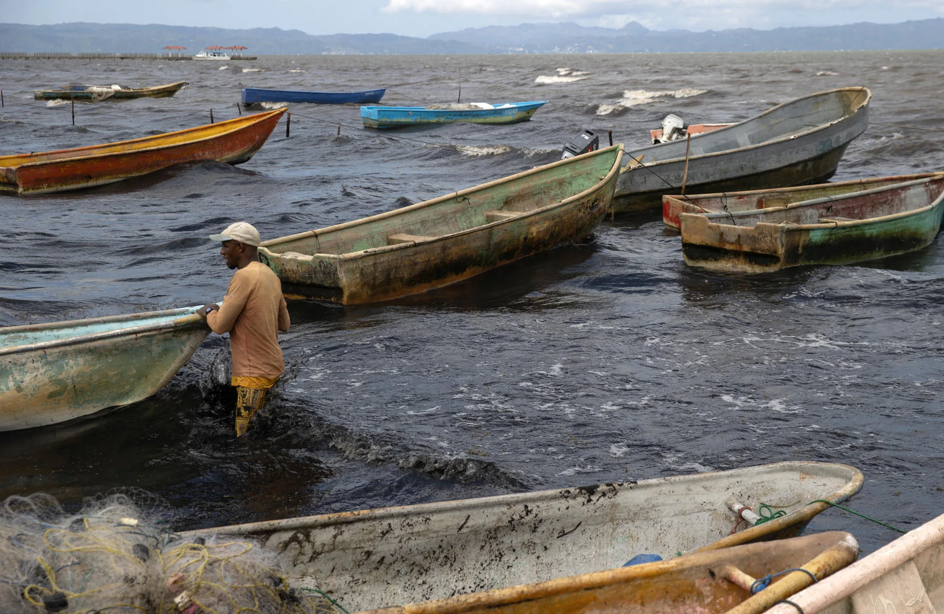 A fisherman pushes a boat on Monday, on the coast of Sabana de la Mar (Dominican Republic). Sept. 1, 2025. EFE/Orlando Barría