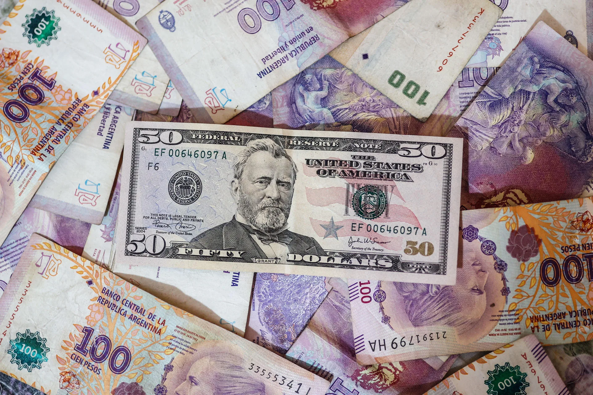 (FILE) Photograph of Argentine dollar and peso bills Apr. 19, 2022. EFE/ Juan Ignacio Roncoroni