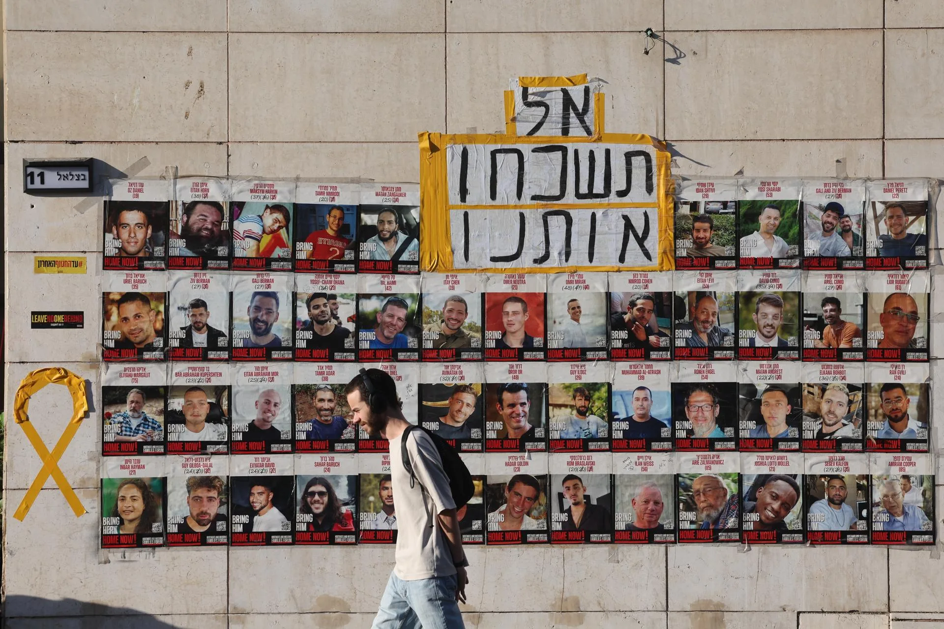 A person walks past pictures of Israeli hostages held by Hamas in Gaza, with a message reading don’t forget us, in central Jerusalem, Sep 15, 2025. EFE/EPA/ABIR SULTAN