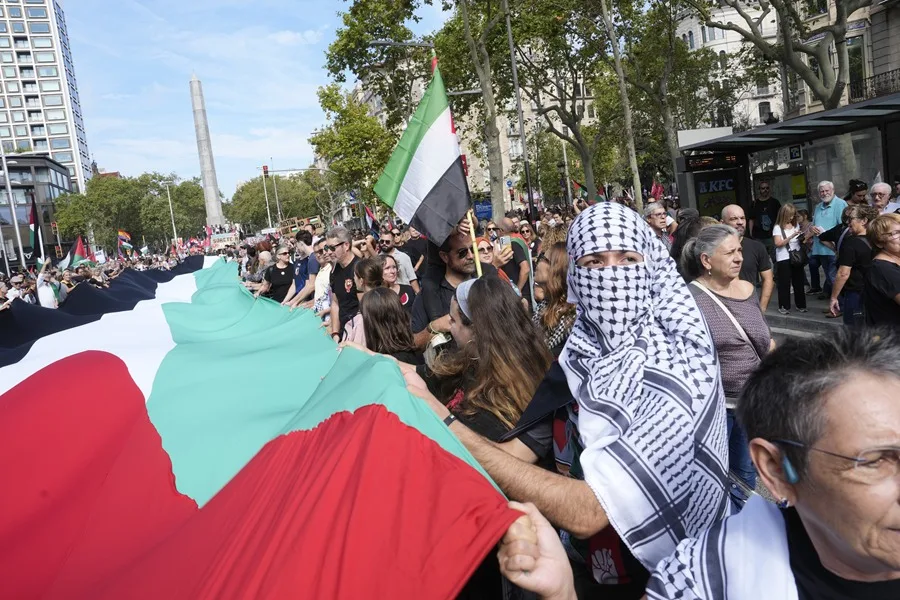 Participantes despliegan una bandera palestina durante la manifestación 