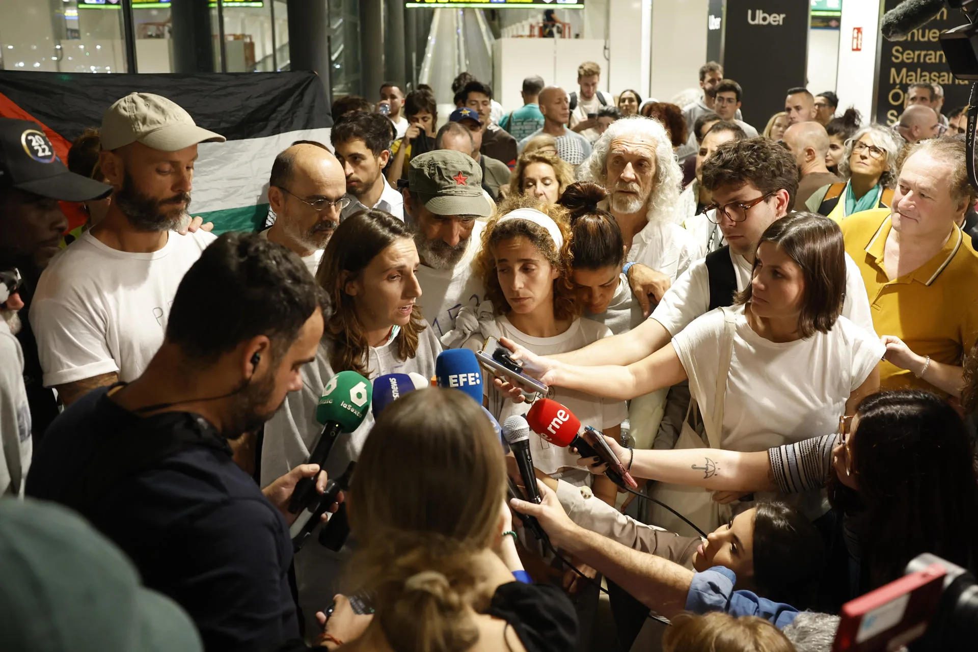 An activist speaks upon the arrival at Barajas Airport in Madrid of another group of Spaniards who were part of the Global Sumud Flotilla, on an A-400 aircraft of the Spanish Air Force. EFE/Juanjo Martín